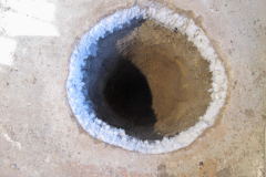 A hole jackhammered into my studio-floor. Each winter the rim shows a crown of ice. Toronto 2015