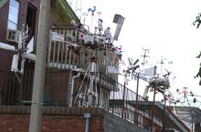A cluster of windmills on a balcony on Robinson.