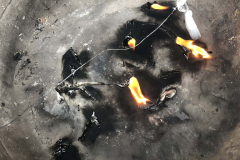 Installation of styrofoam lids burning over a metal tub. Toronto 2019