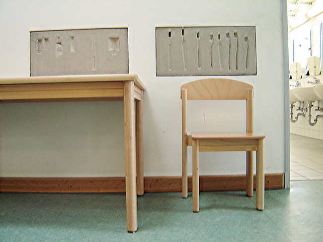 photo of table and chair with concrete cast in wall